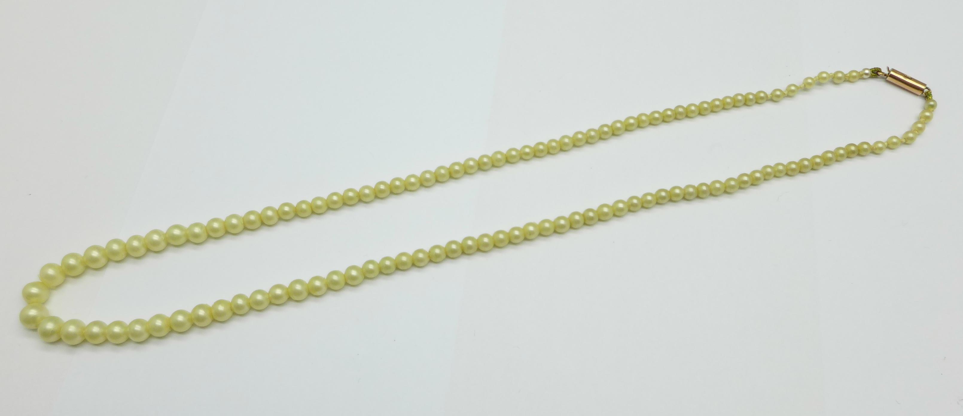 A string of pearls with 9ct gold clasp