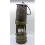 An Ackroyd & Best miner's safety lamp