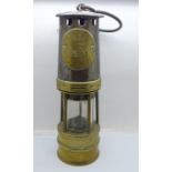 An Ackroyd & Best miner's safety lamp