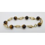 A yellow metal and tigers eye bracelet, continental control marks