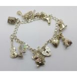 A silver charm bracelet with eleven charms, 19g