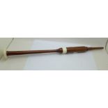 A turned wooden and ivory bagpipe chanter