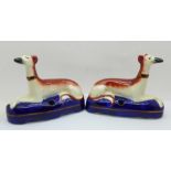 A pair of Staffordshire pottery laying greyhound pen holders