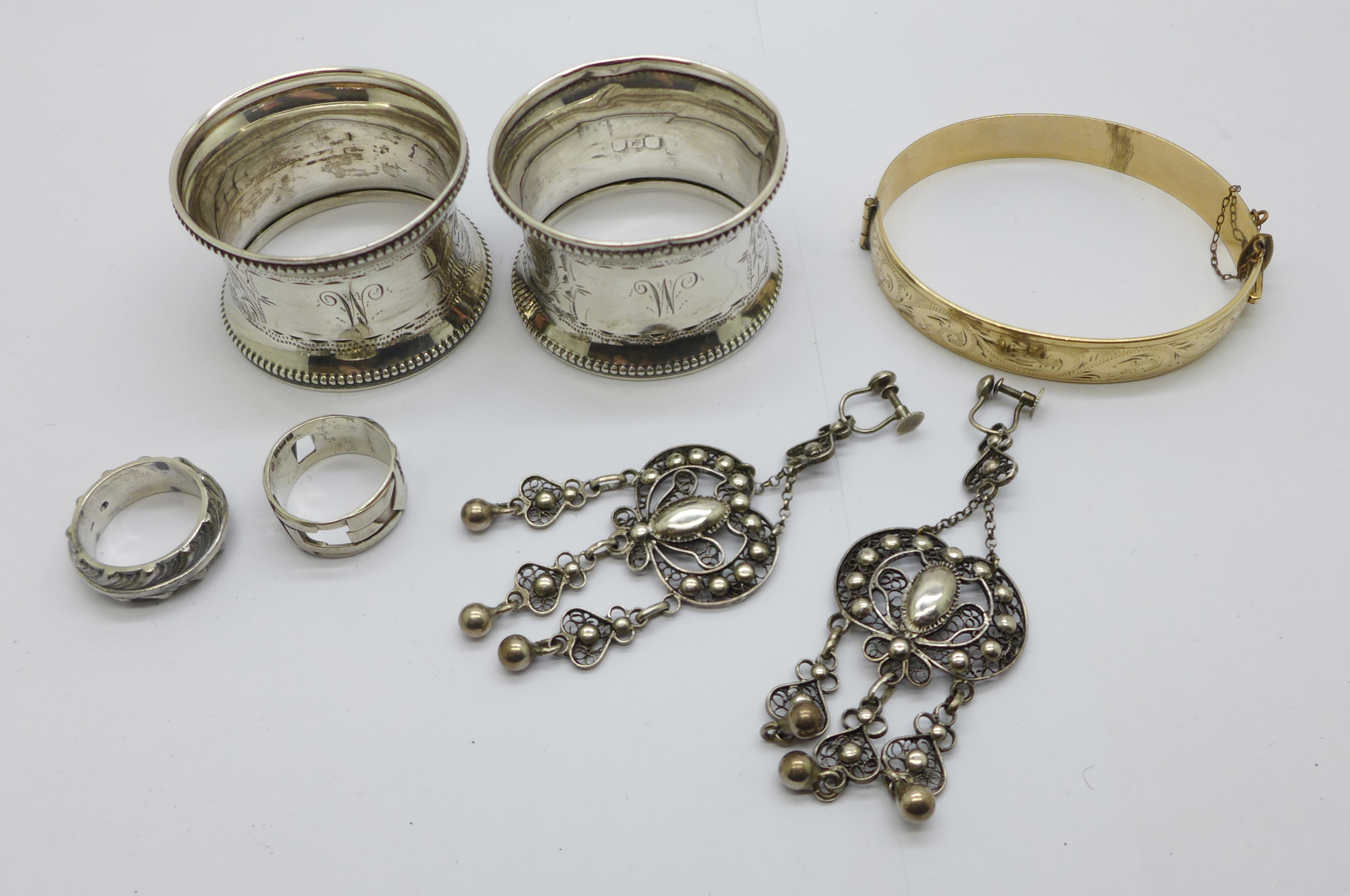 A pair of silver napkin rings, Birmingham 1918, 21g, two silver rings, one Birmingham 1976, a pair