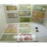 A collection of bank notes and two coins, 1873 French coin and 1952 East Africa 10 cents