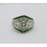 A yellow metal, Art Deco style green and white stone ring with green border, lacking one stone,