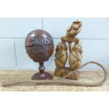 A carved monkey figure, a carved globe pot and a wood whip