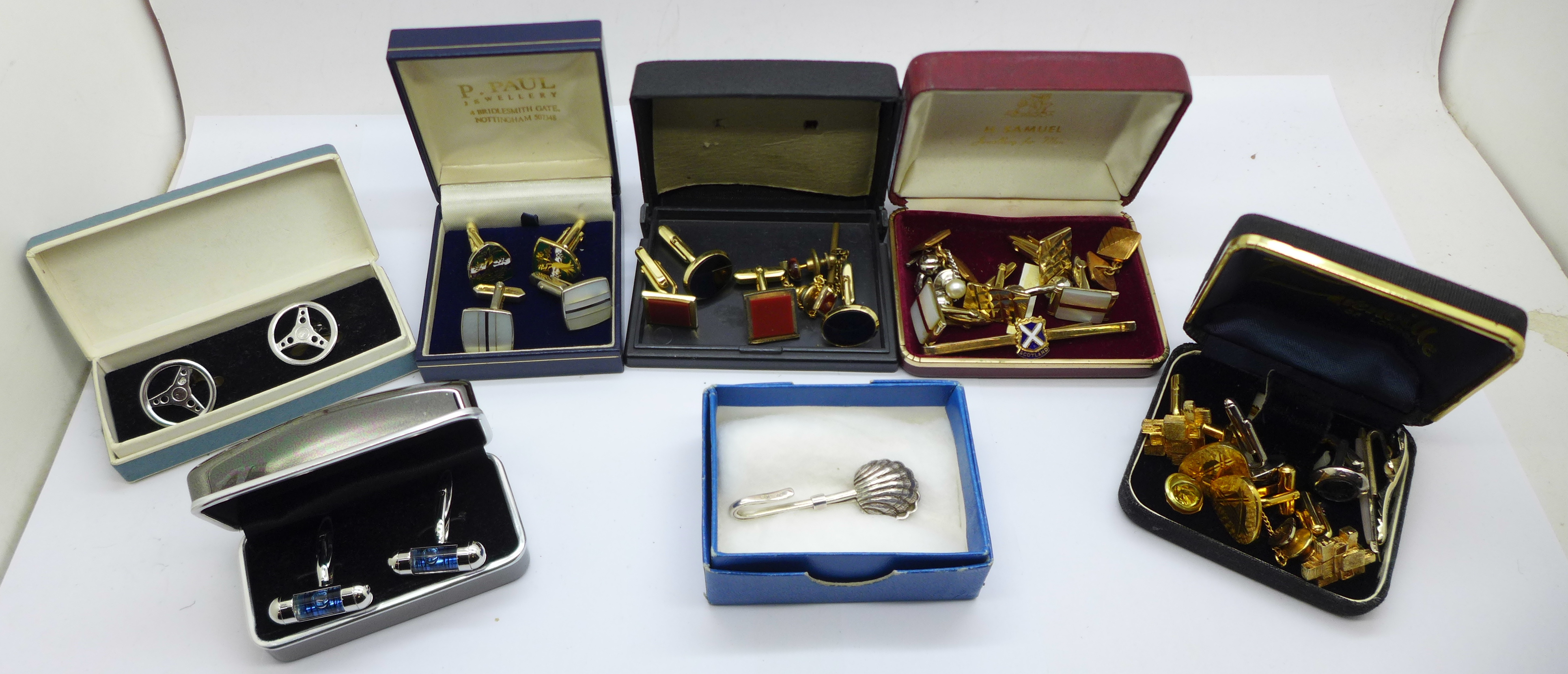 A collection of cufflinks, tie pins and a hallmarked silver napkin holder/clip