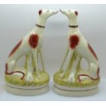 Two Staffordshire pottery sitting greyhounds, 23cm