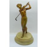 A 1930's Art Deco Lorenzl figure of a golfer, on a circular base, restored/repaired on the left leg,