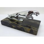 A leaping Jaguar car mascot mounted on a marble base