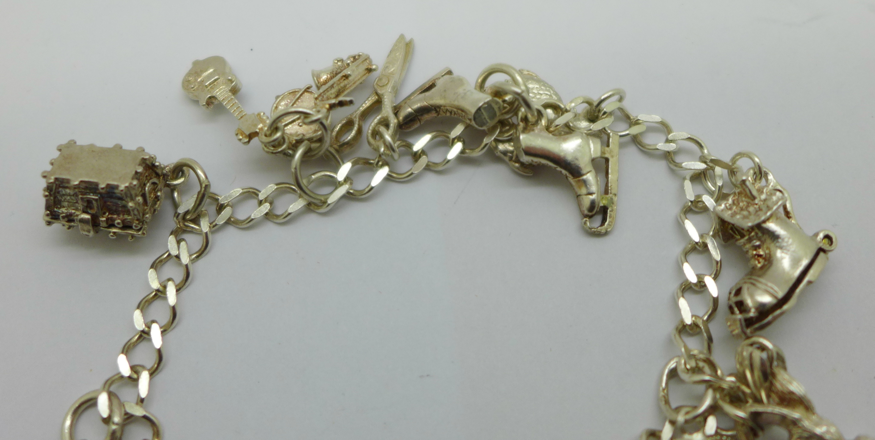 A silver charm bracelet with eleven charms, 19g - Bild 8 aus 8