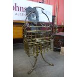 A Victorian Aesthetic Movement brass revolving newspaper stand