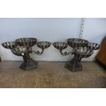 A pair of Gothic style cast iron candle holders