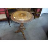 A Victorian carved walnut and marquetry inlaid tripod table