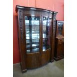 A Hepplewhite Revival carved mahogany two door bow front side cabinet