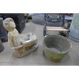 A figural concrete garden planter and another