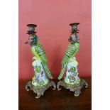 A pair of French style porcelain and ormolu mounted figural parrot candlesticks