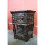 A 17th Century style carved oak credence cupboard