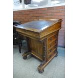 A Victorian rosewood sliding top Davenport, stamped James Winter, 101 Wardour St., London