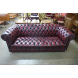A Chesterfield red leather settee
