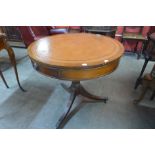 A Regency style mahogany and leather topped drum shaped table