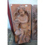 A faux terracotta fibre glass cherub plaque