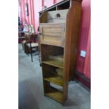 A small Arts and Crafts oak open bookcase