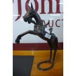 A bronze figure of a rearing horse