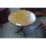 A George III oak and mahogany circular tilt top tripod table