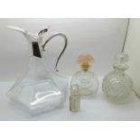 A glass claret jug with plated top and three scent bottles