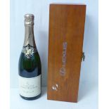 A bottle of champagne, Moutard Brut Grande Cuvee, in a presentation box marked Lexus