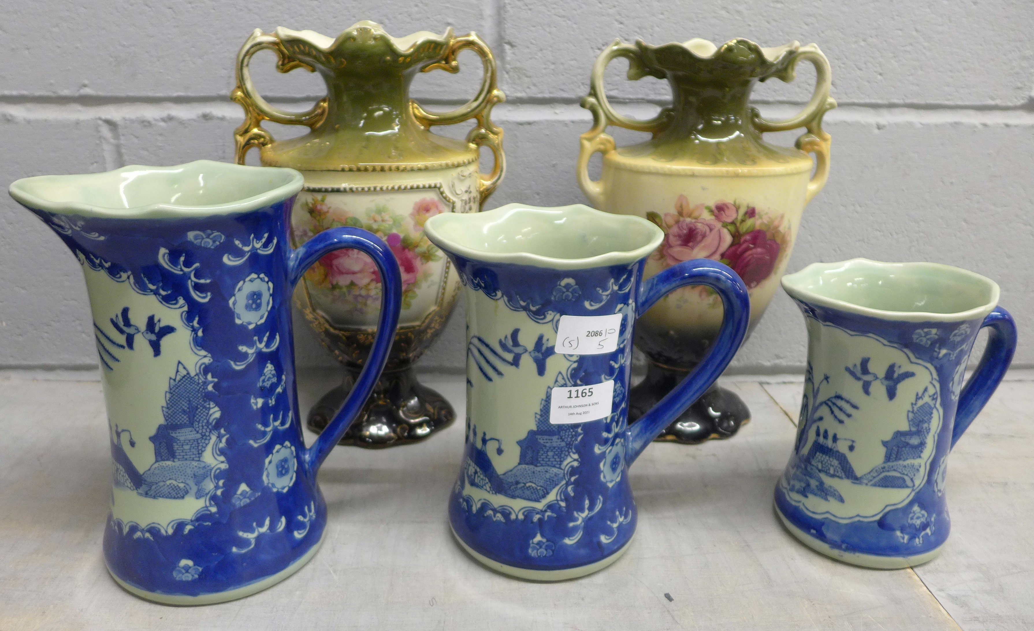 A pair of vases and a set of three jugs **PLEASE NOTE THIS LOT IS NOT ELIGIBLE FOR POSTING AND