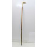 A 19th Century gentleman's walking stick, the L-shaped ivory handle carved with faux buttoned