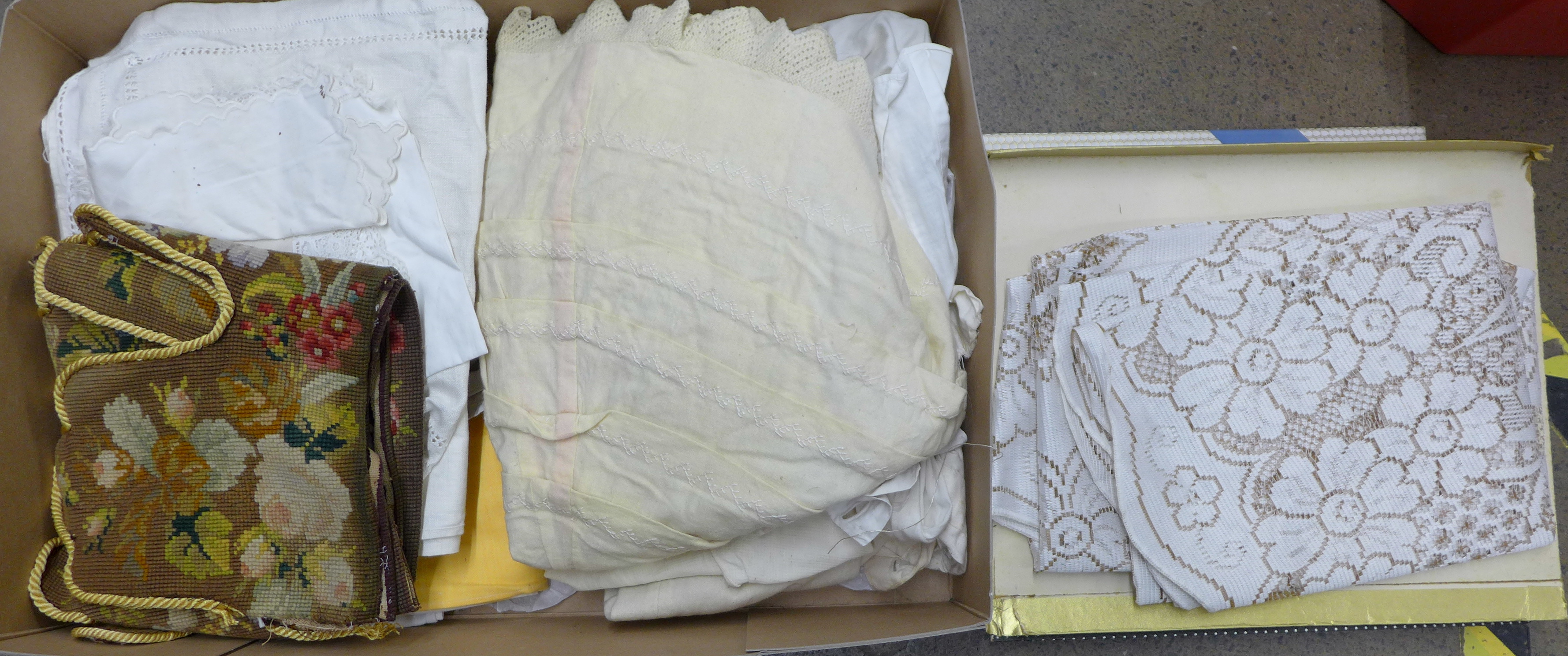 A box of Victorian and later table linen, children's clothing, a woolwork table or mantelpiece