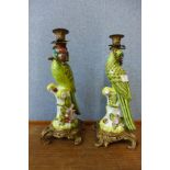 A pair of French style porcelain and ormolu mounted figural parrot candlesticks