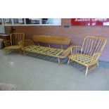 An Ercol Blonde elm and beech 355 model studio couch and pair of matching armchairs