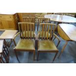 A set of four teak dining chairs