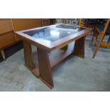 A teak and glass topped coffee table