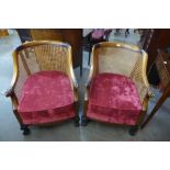 A pair of 1930's carved walnut bergere armchairs