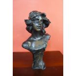 An Art Nouveau style bust bronze effect bust of a lady