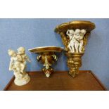 A gilt cherub wall sconce, another wall sconce and a resin figure of two cherubs