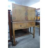 An oak two door cupboard on stand