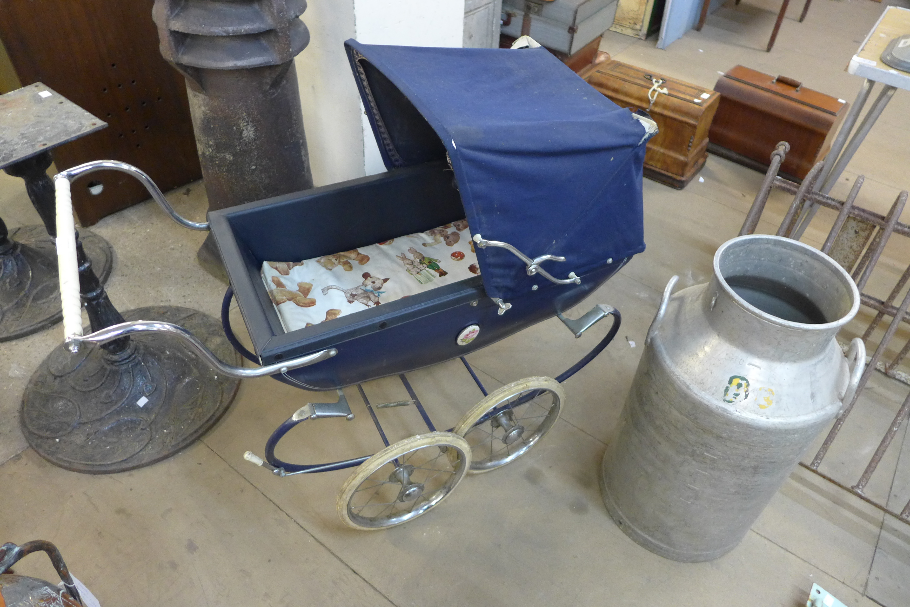 A Silver Cross dolls perambulator and an aluminium milk churn