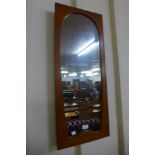 A teak framed mirror