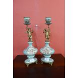 A pair of French style porcelain and ormolu mounted figural cherub candlesticks