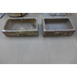 A pair of concrete troughs