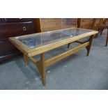 A Stonehill Stateroom teak and glass topped coffee table