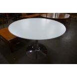 An Eero Saarinen style chrome based circular dining table