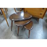 An Ercol dark elm and beech pebble shaped nest of tables